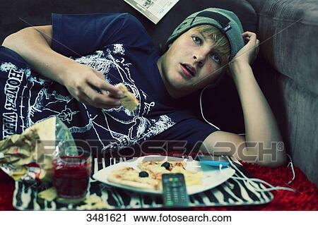 France teenager eating and watching TV View Large Photo Image Stock Image - France teenager eating and watching TV. Fotosearch
