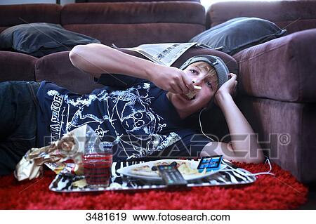 France teenager eating and watching TV View Large Photo Image Stock Photo - France teenager eating and watching TV. Fotosearch