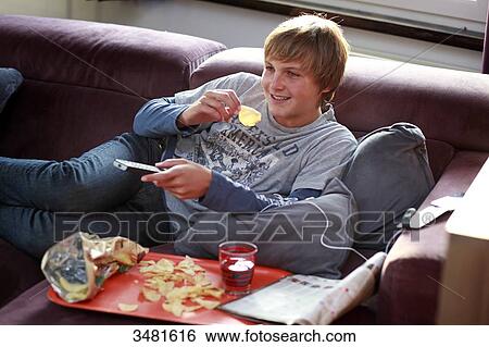 France teenager eating and watching TV View Large Photo Image Stock Photograph - France teenager eating and watching TV. Fotosearch
