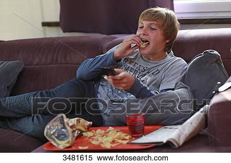 France teenager eating and watching TV View Large Photo Image Stock Photography - France teenager eating and watching TV. Fotosearch