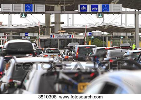 Stock Photo - France, traffic jam at customs, border in Eurotunnel area on the French side. Englsih coming home from vacation.. Fotosearch