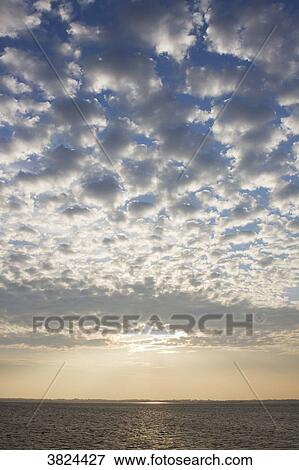 France, Vendee, island of Noirmoutier, cloudy sky at sunset on the sea. View Large Photo Image Stock Photo - France, Vendee, island of Noirmoutier, cloudy sky at sunset on the sea.. Fotosearch