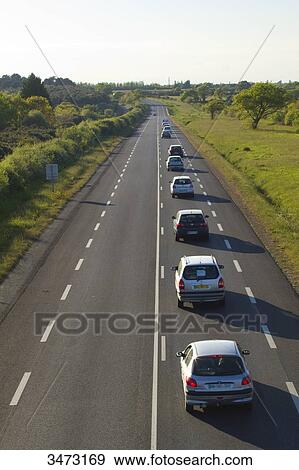 Stock Photo - France, Western France, Les Moutiers-en-Retz, traffic on D13 road. Fotosearch