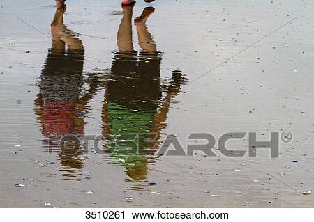 France, Western France, Saint-Gilles-Croix-de-Vie, reflections of tourists walking on the sand at low tide. View Large Photo Image Stock Image - France, Western France, Saint-Gilles-Croix-de-Vie, reflections of tourists walking on the sand at low tide.. Fotosearch