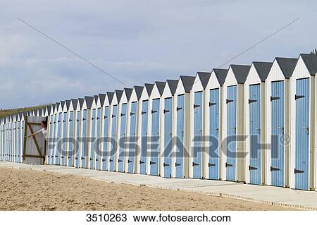 Stock Image - France, Western France, Saint-Gilles-Croix-de-Vie, lined-up bathing huts. One hut is open.. Fotosearch