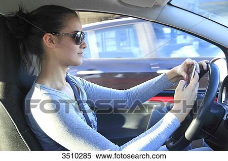 France, woman driving and using smartphone View Large Photo Image Stock Photography - France, woman driving and using smartphone. Fotosearch