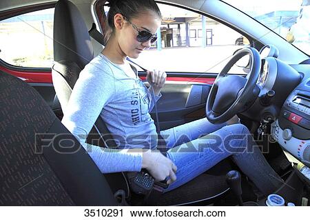 France, woman fastening seat belt View Large Photo Image Stock Image - France, woman fastening seat belt. Fotosearch