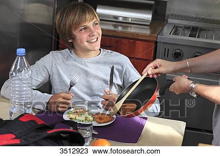 Stock Image - France, young boy eating. Fotosearch