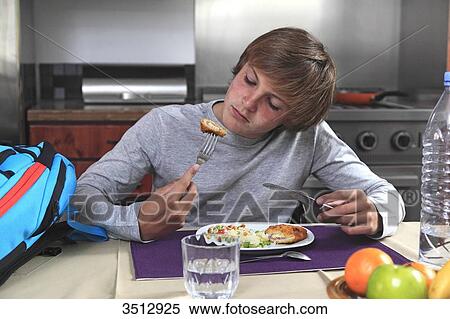 Stock Photography - France, young boy eating. Fotosearch