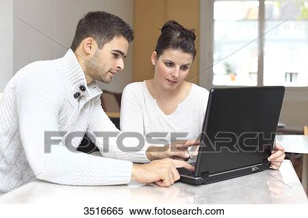 France, young couple at home using laptop View Large Photo Image Stock Photography - France, young couple at home using laptop. Fotosearch