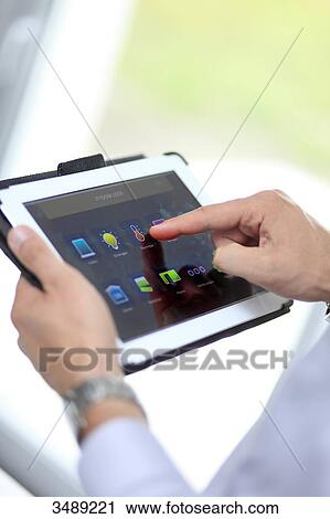 France, young man with tablet in his home View Large Photo Image Stock Image - France, young man with tablet in his home. Fotosearch
