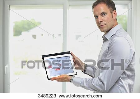 France, young man with tablet in his home View Large Photo Image Stock Image - France, young man with tablet in his home. Fotosearch