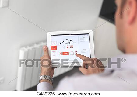 France, young man with tablet in his home View Large Photo Image Stock Photograph - France, young man with tablet in his home. Fotosearch