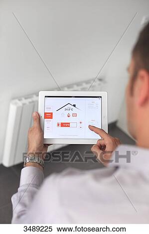 France, young man with tablet in his home View Large Photo Image Stock Photography - France, young man with tablet in his home. Fotosearch