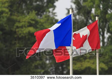 Stock Photo - French and canadian flags side by side.. Fotosearch