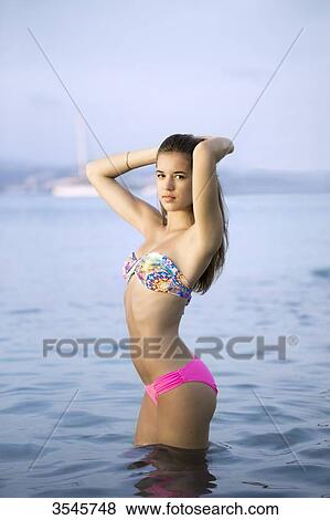 Girl posing in a swimsuit in water View Large Photo Image Stock Photo - Girl posing in a swimsuit in water. Fotosearch