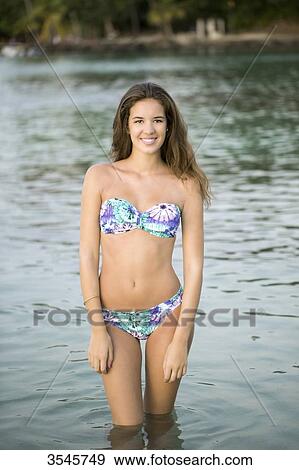 Girl posing in a swimsuit in water View Large Photo Image Stock Photo - Girl posing in a swimsuit in water. Fotosearch