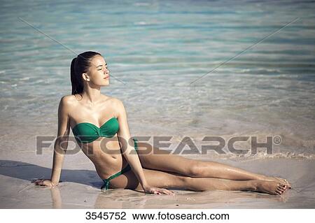 Girl sunbathing at the beach View Large Photo Image Stock Image - Girl sunbathing at the beach. Fotosearch