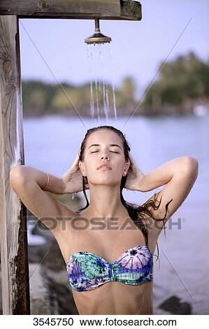 Girl taking a shower on the beach View Large Photo Image Stock Image - Girl taking a shower on the beach. Fotosearch