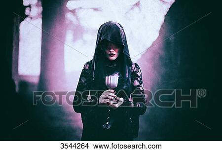 Gothic woman holding a chalice View Large Photo Image Picture - Gothic woman holding a chalice. Fotosearch