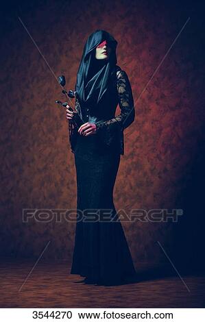 Gothic woman holding a rose View Large Photo Image Stock Image - Gothic woman holding a rose. Fotosearch