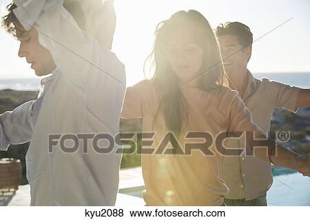 Group of friends dancing at the poolside View Large Photo Image Stock Photo - Group of friends dancing at the poolside. Fotosearch