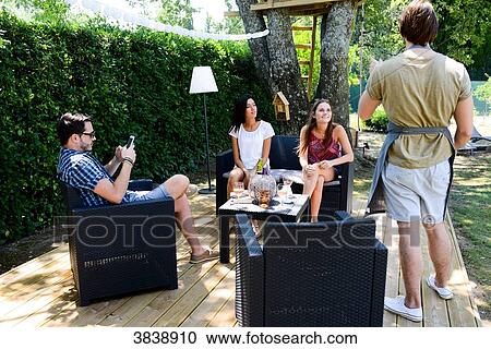 Group of young and cheerful people having a toast in a garden party outdoor in the backyard during summer holiday. View Large Photo Image Stock Image - Group of young and cheerful people having a toast in a garden party outdoor in the backyard during summer holiday.. Fotosearch