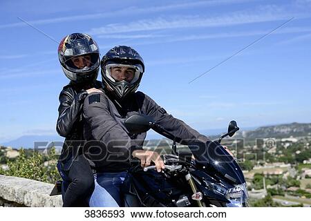 Happy young biker couple riding motorbike in summer. View Large Photo Image Stock Image - Happy young biker couple riding motorbike in summer.. Fotosearch