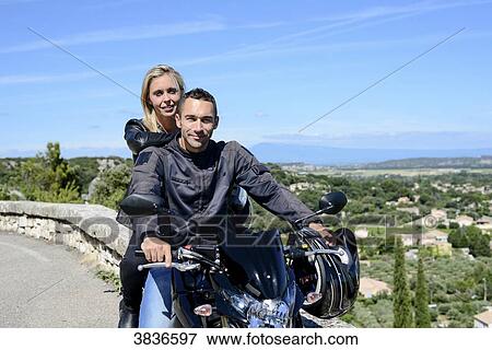 Happy young biker couple riding motorbike in summer. View Large Photo Image Stock Photo - Happy young biker couple riding motorbike in summer.. Fotosearch