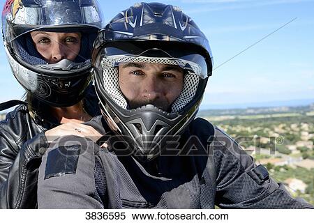 Happy young biker couple riding motorbike in summer. View Large Photo Image Stock Photography - Happy young biker couple riding motorbike in summer.. Fotosearch