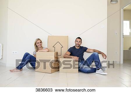 Happy young couple carrying cardboard boxes and moving into their new house. View Large Photo Image Stock Image - Happy young couple carrying cardboard boxes and moving into their new house.. Fotosearch