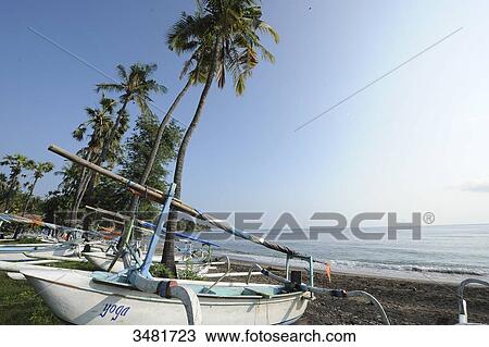 Indonesia, Bali, Amed, the beach with Prahus, the famous outrigger canoes. View Large Photo Image Stock Image - Indonesia, Bali, Amed, the beach with Prahus, the famous outrigger canoes.. Fotosearch