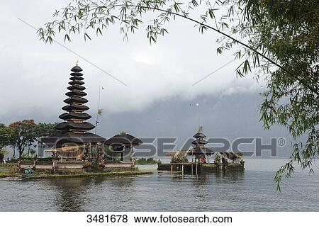 Stock Photo - Indonesia, Bali, Bedugul, the temple of Ulun Danu is located on the shores of Lake Bratan. The Temple with its Atap Meru (bunk roofs) of 11 roofs is dedicated to the goddess of the waters. Fotosearch