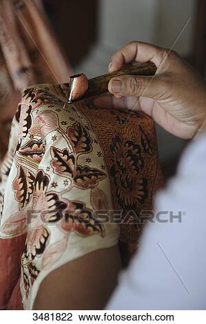 Indonesia, Bali, Celuk, Batik Manufacturing, The technique consists in drawing a pattern on a fabric, protecting the fabric against staining by an application of hot wax, then applying the color by soaking in dye bath View Large Photo Image Stock Image - Indonesia, Bali, Celuk, Batik Manufacturing, The technique consists in drawing a pattern on a fabric, protecting the fabric against staining by an application of hot wax, then applying the color by soaking in dye bath. Fotosearch