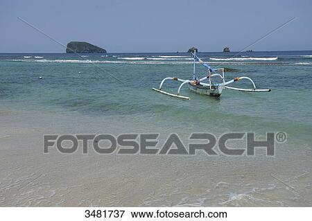 Indonesia, Bali, the beach of Kelapa Mas with a Prahus, the famous outrigger canoes. View Large Photo Image Stock Photo - Indonesia, Bali, the beach of Kelapa Mas with a Prahus, the famous outrigger canoes.. Fotosearch