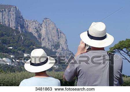 Stock Image - Italy, Amalfi Coast, Capri, Tourists with white hats. Fotosearch