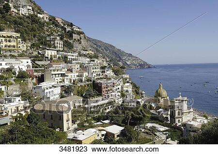 Stock Image - Italy, Amalfi Coast, Positano, old fishermen village with the Santa Maria Assunta church and its dome covered in varnished tiles, near the beach. Fotosearch