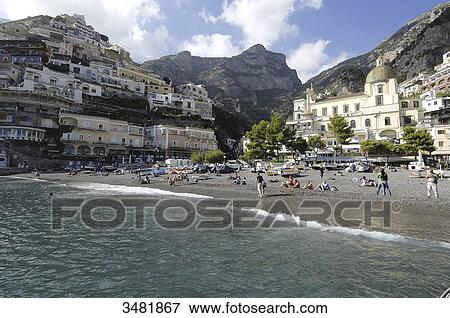 Italy, Amalfi Coast, Positano, panorama of the old fishermen village surrounded by mountains, with the Santa Maria Assunta church and its dome covered in varnished tiles, near the beach View Large Photo Image Stock Photo - Italy, Amalfi Coast, Positano, panorama of the old fishermen village surrounded by mountains, with the Santa Maria Assunta church and its dome covered in varnished tiles, near the beach. Fotosearch