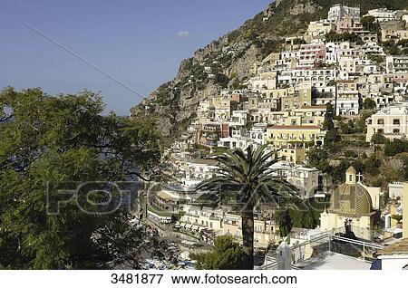 Italy, Amalfi Coast, Positano, panorama of the old fishermen village surrounded by mountains, with the Santa Maria Assunta church and its dome covered in varnished tiles, near the beach View Large Photo Image Stock Photo - Italy, Amalfi Coast, Positano, panorama of the old fishermen village surrounded by mountains, with the Santa Maria Assunta church and its dome covered in varnished tiles, near the beach. Fotosearch