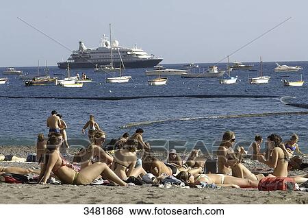 Stock Photo - Italy, Amalfi Coast, Positano, the beach with tourists looking at cruise ship.. Fotosearch
