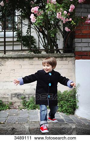 Stock Image - Little boy crossing the street. Fotosearch