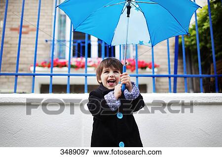 Little boy with an umbrella View Large Photo Image Stock Photo - Little boy with an umbrella. Fotosearch