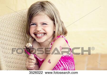 Little girl eating chocolate ice cream View Large Photo Image Stock Image - Little girl eating chocolate ice cream. Fotosearch