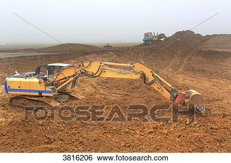 Stock Photograph - Machines on a building site of earthwork.. Fotosearch