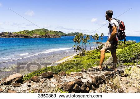 Man looking at the sea and an island, Petit Nevis, Saint-Vincent and the Grenadines, West Indies View Large Photo Image Stock Photo - Man looking at the sea and an island, Petit Nevis, Saint-Vincent and the Grenadines, West Indies. Fotosearch