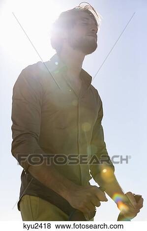 Stock Photo - Man standing with a baby stroller. Fotosearch