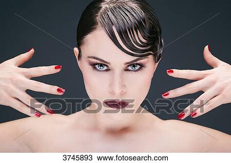 Manicure: Portrait of a young woman with her hands, looking toward the lens View Large Photo Image Stock Image - Manicure: Portrait of a young woman with her hands, looking toward the lens. Fotosearch