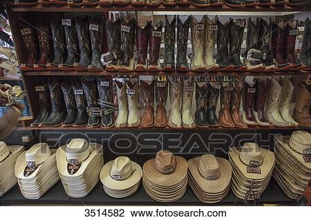 Stock Image - Mexico, Chihuahua State, Chihuahua, Store of cowboys boots and hats. Fotosearch