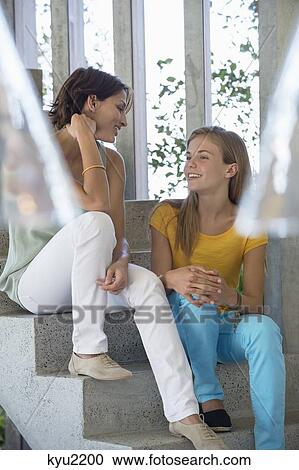 Mother and daughter sitting on steps and talking to each other View Large Photo Image Stock Image - Mother and daughter sitting on steps and talking to each other. Fotosearch
