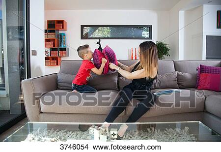 Mother and son playing on the couch View Large Photo Image Picture - Mother and son playing on the couch. Fotosearch